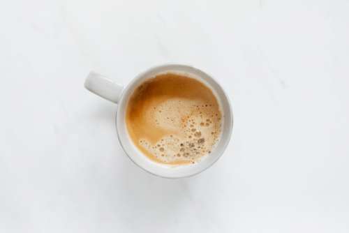 A cup of coffee on white marble