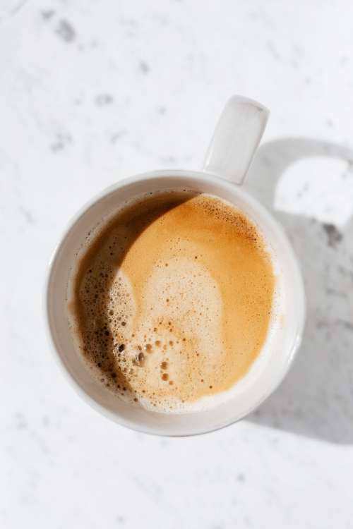 A cup of coffee on white marble