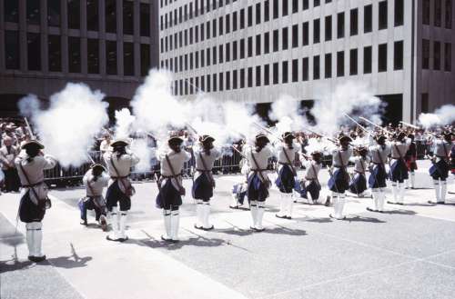 Soldiers firing weapons in downtown ceremony, Montreal, Canada