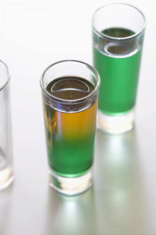 Green drinks in shot glasses