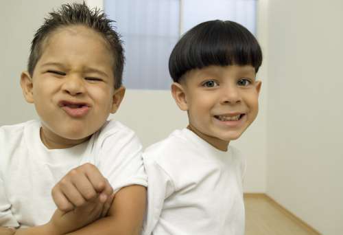 Two young boys making faces
