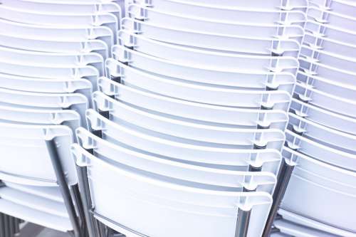 Rows of plastic white chairs