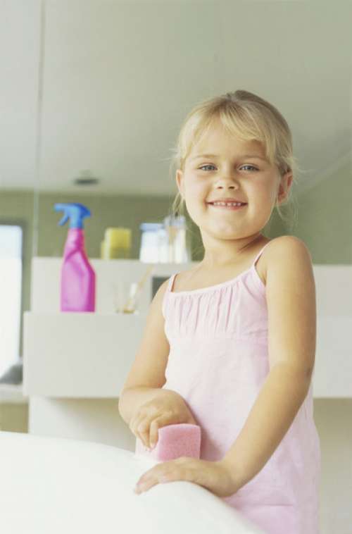 Portrait of a girl cleaning a bathtub