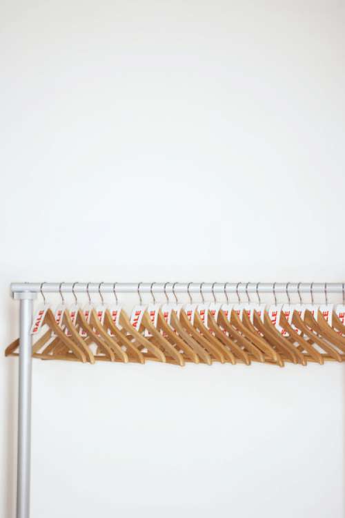 Clothes hangers with sale tags attached on clothes rail
