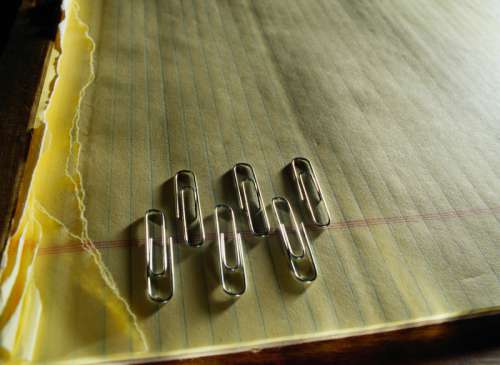 Six Paper Clips on a Legal Pad