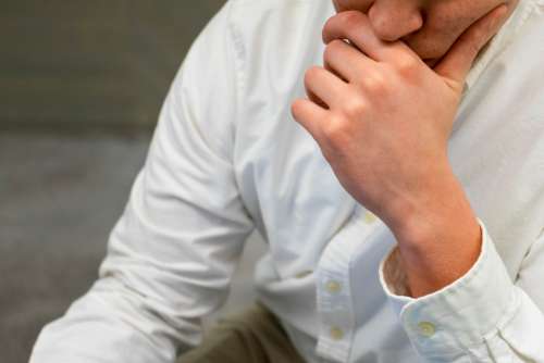 man thinking hand close up puzzled