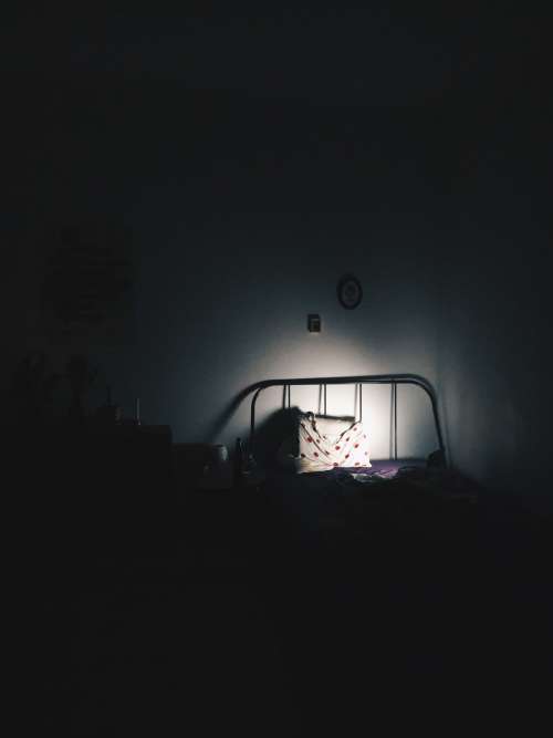 Pillow On Bed In A Dark Room Photo