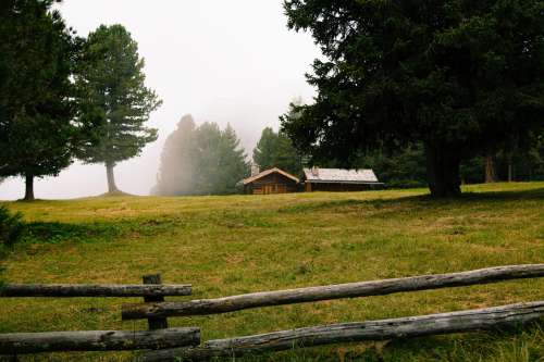Log Cabin On A Misty Day Surrounded By Rail Fence Photo