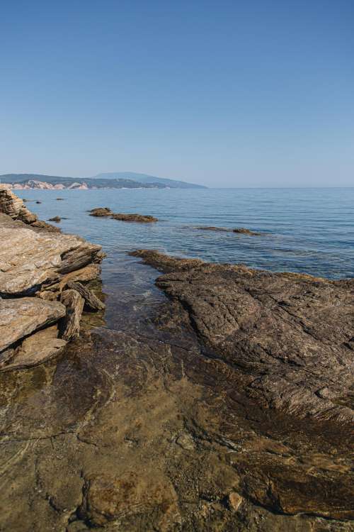 Rocky Coast With Open Ocean And Blue Sky Photo