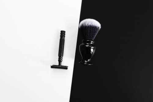 Razor And Shaving Brush On Black And White Photo