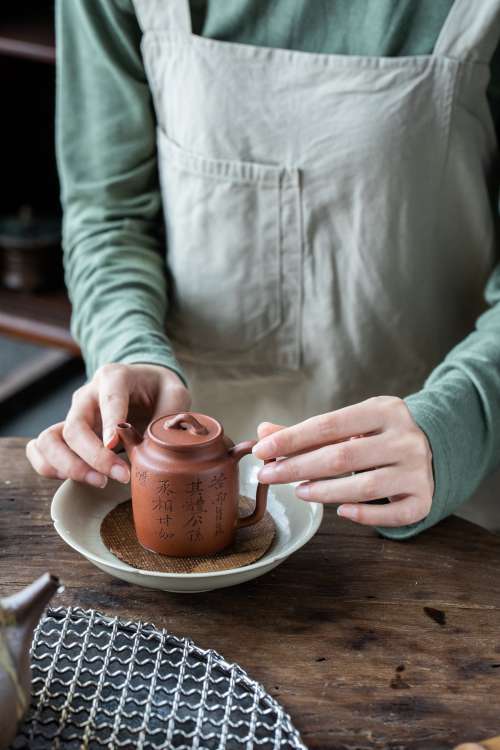 Placing Ceramic Teapot Within White Bowl Photo