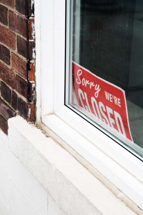 Sorry We're Closed Sign In Window Photo