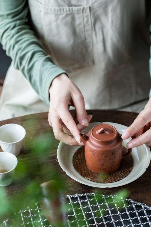 Teapot In A Womans Hands Photo