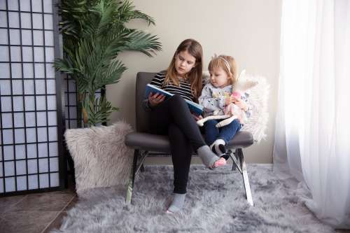 Two Sisters Reading Together Photo