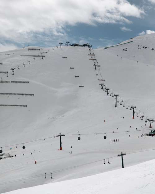 Ski Lifts Making Their Way Up A Mountain Photo