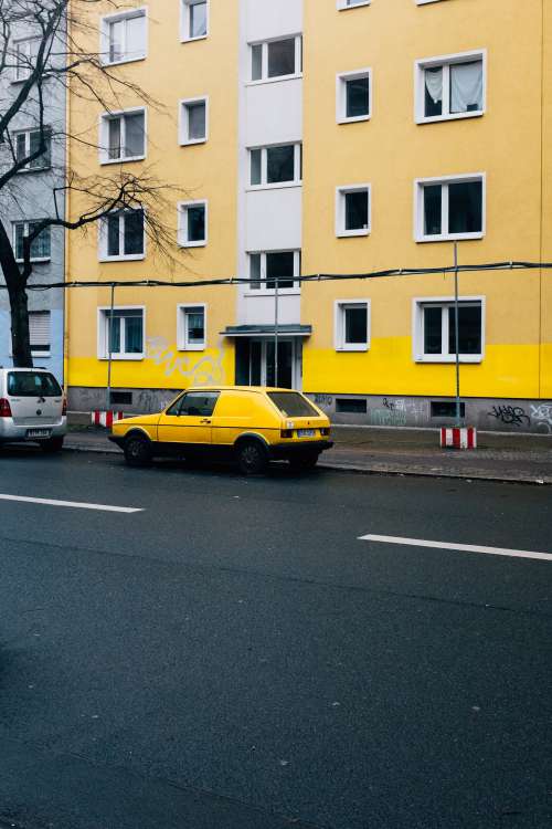 Yellow Car And Building Photo