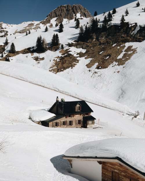 House At The Foot Of Snowy Mountain Photo