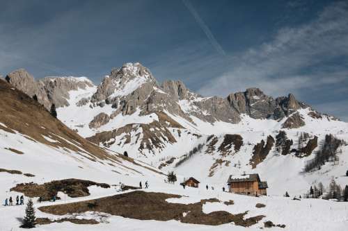 Tourists Head Back To Snowy Log Cabins Photo