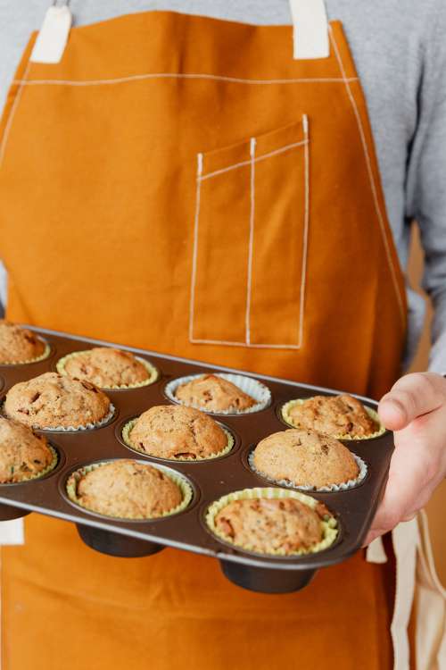 Baker Holding Fresh Muffins Photo