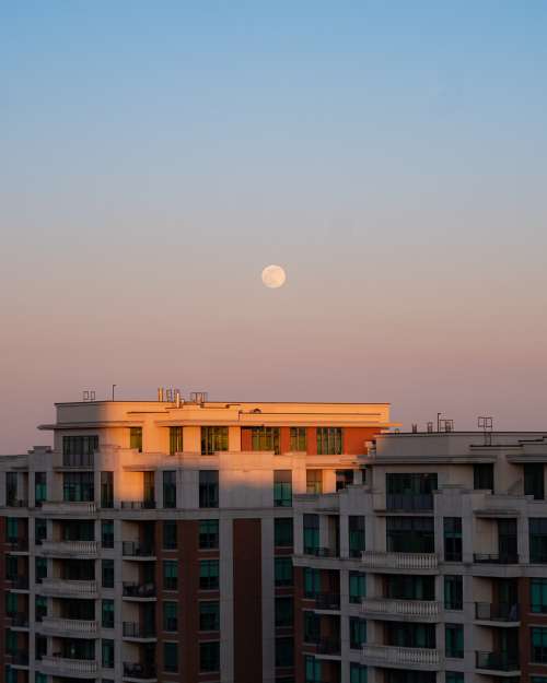 A Full Moon Over Buildings Photo