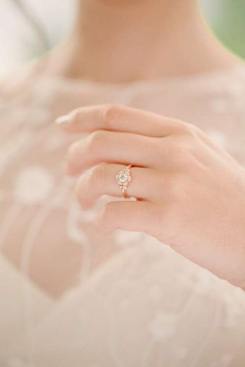 Bride Holds Up Wedding Ring Photo