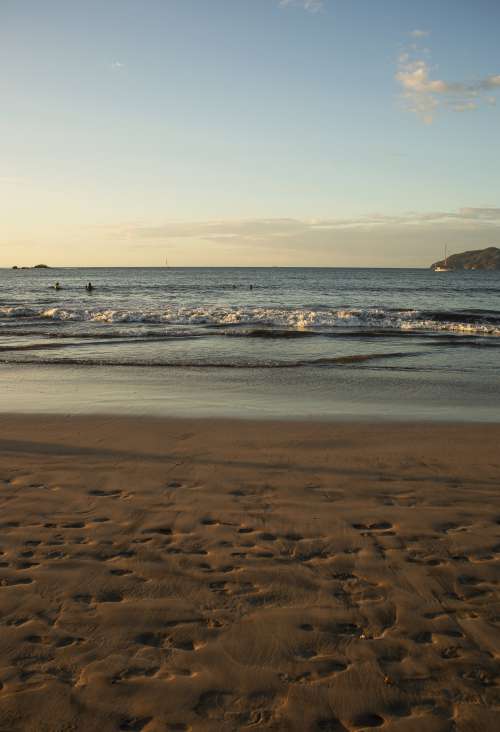 The Tide Rolls In On A Sunny Beach Scene Photo