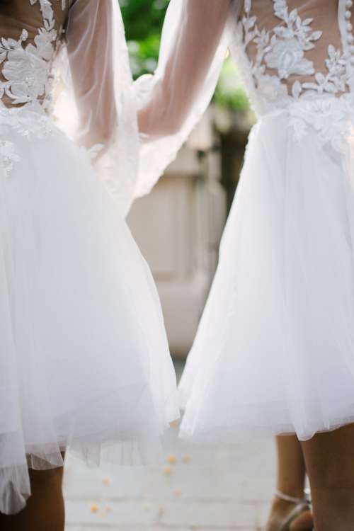Two Bridesmaids Walking Down The Aisle Photo