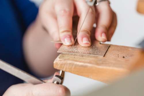 Womens Hand Cutting Metal Surface Photo