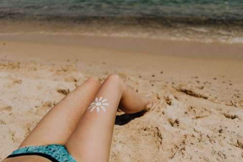 A beautiful blonde sunbathing on a beach in Sardinia