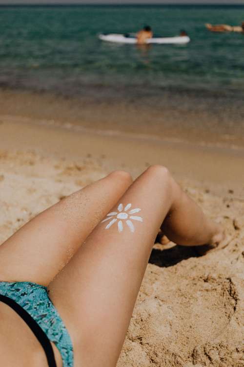 A beautiful blonde sunbathing on a beach in Sardinia