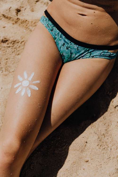 A beautiful blonde sunbathing on a beach in Sardinia