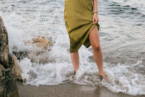 A beautiful woman on the beach is talking on the phone