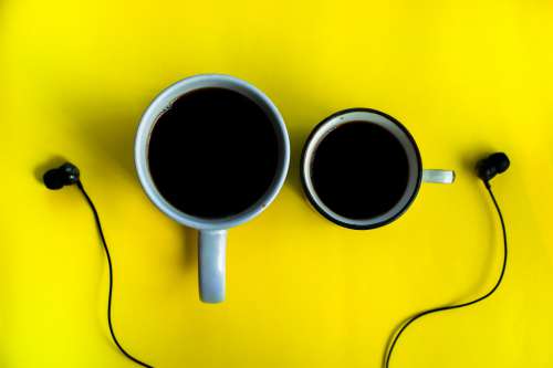 Coffee And Earphones On Yellow Background Photo