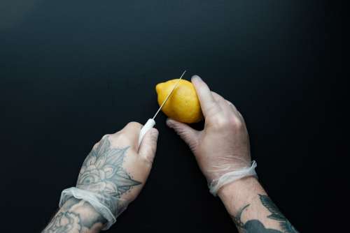 Man With Tattooed Hands Prepping Food Photo