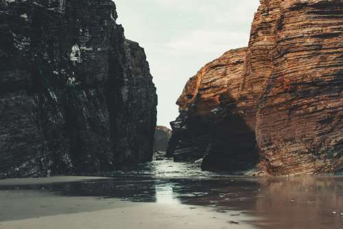 Tide Rolls Into Shore Between Rocks Photo