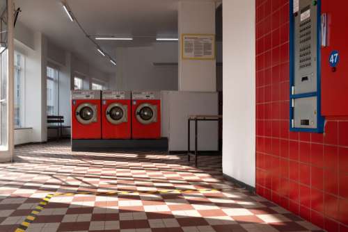 Empty Laundromat In Red Photo