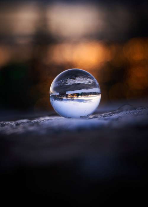Close Up Of Glass Ball In Landscape Photo