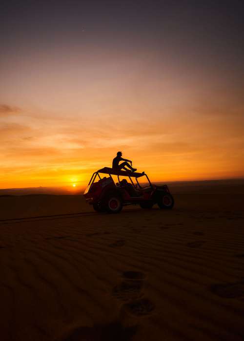 Dune Buggy In Front Of Setting Sun Photo