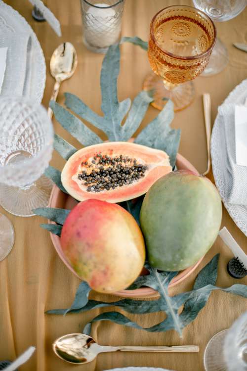Papaya Fruit At Centre Of Table Setting Photo