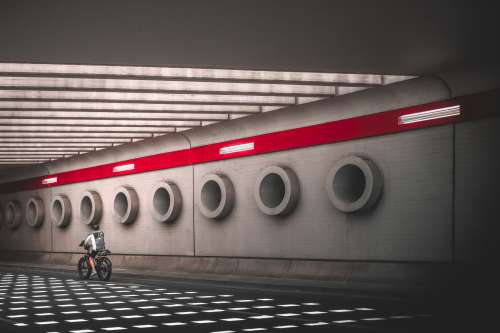 Cyclist Riding Through Stunning Underpass Photo