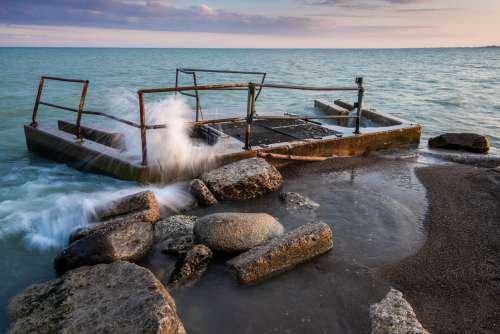 Waves Crashing Over Beach Structure Photo