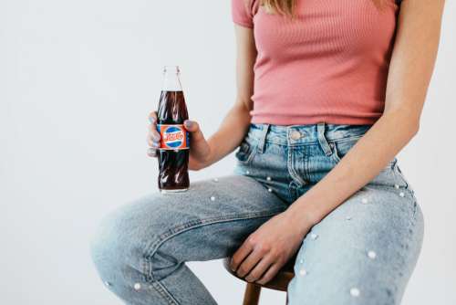 Young woman with Pepsi Cola bottle