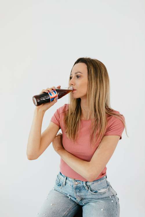 Young woman with Pepsi Cola bottle