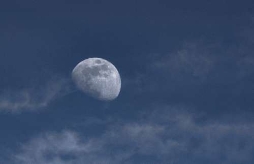 Moon In Cloudy Blue Sky