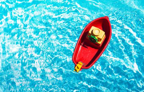 Red Toy Boat In A Swimming Pool Photo