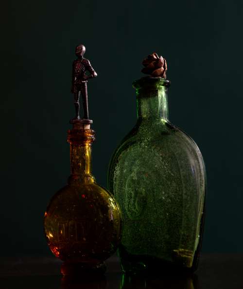 Two Glass Bottles With Ornate Tops Photo