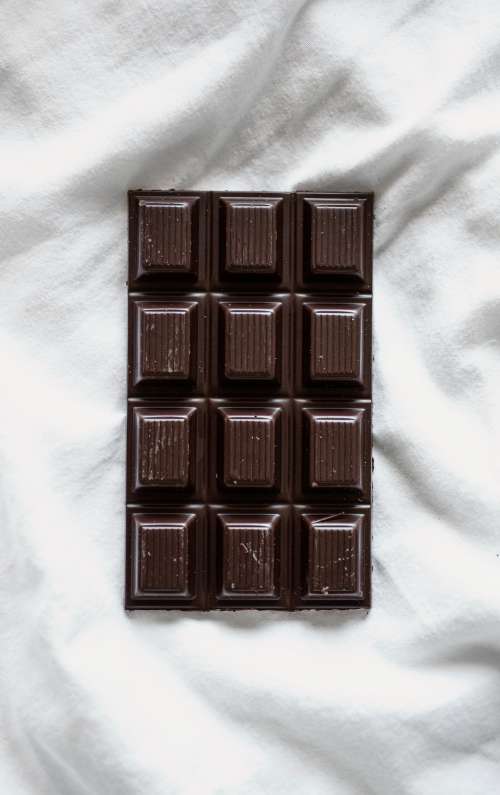 A Bar Of Dark Chocolate On White Photo