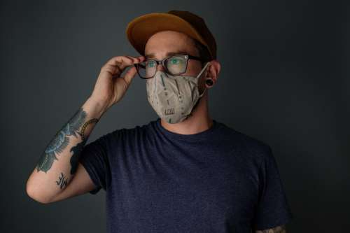 Man Wearing Mask Adjusting His Glasses Photo