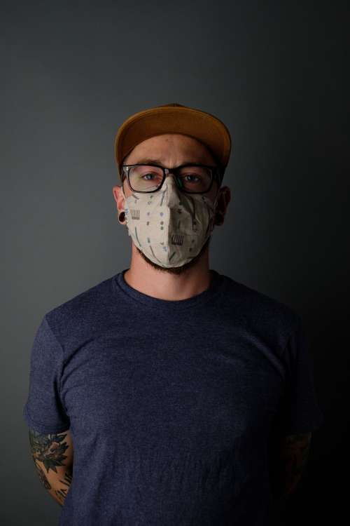 Portrait Of Tattooed Man Wearing Mask Photo