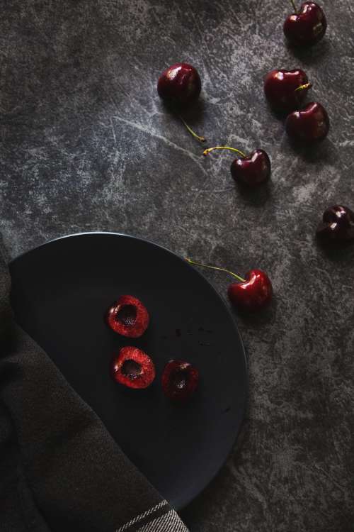 Fresh Cherries Scattered On Dark Background Photo